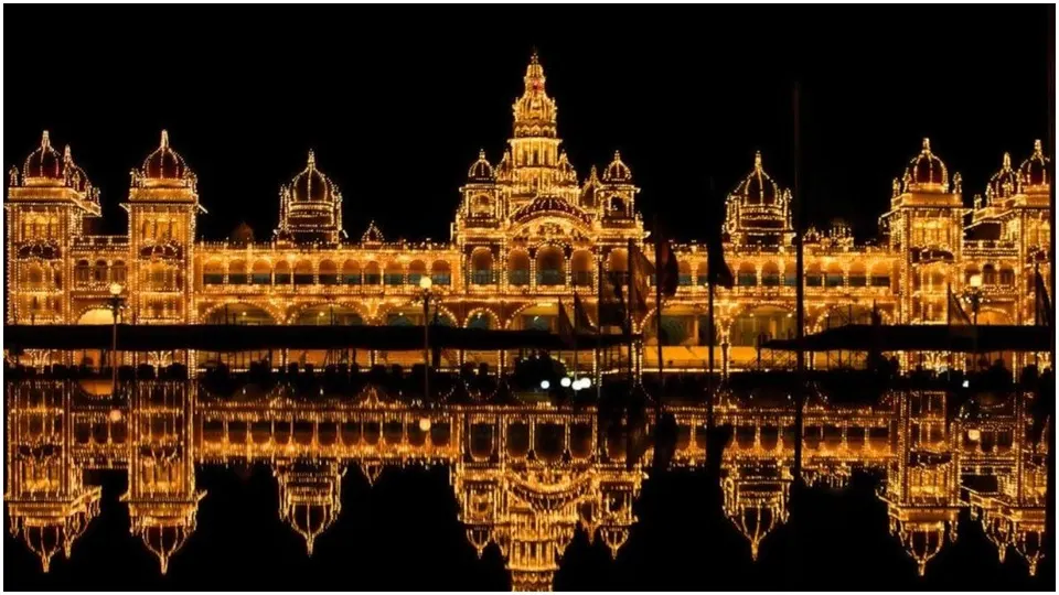 The illuminated palace mirrored in still water